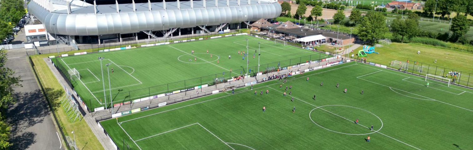 Luchtfoto van Sportpark Ossenkoppelerhoek met de voetbalvelden van Oranje Nassau en het stadion op de achtergrond
